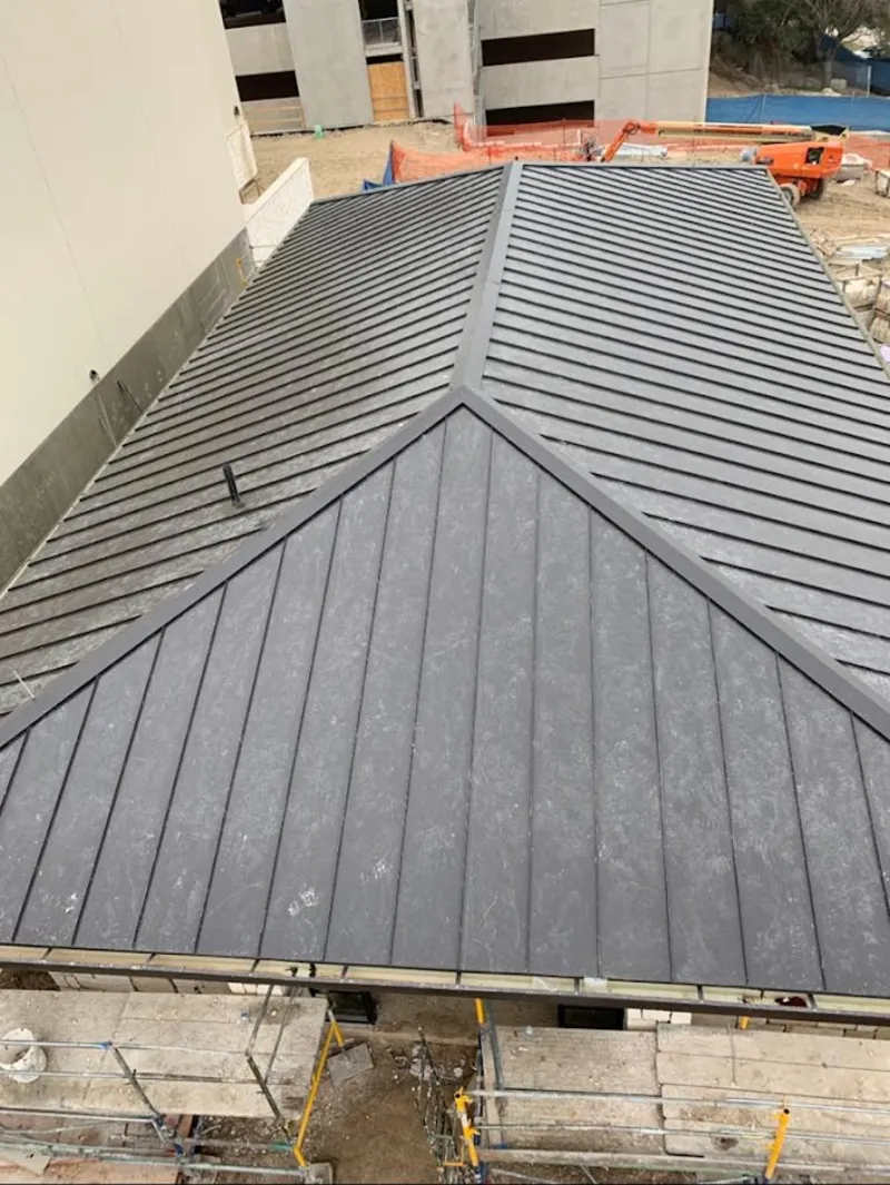 Commercial metal roof construction with crane equipment in Kenmore